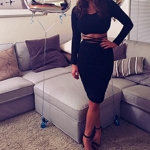Long sleeve black crop top with ties along stomach